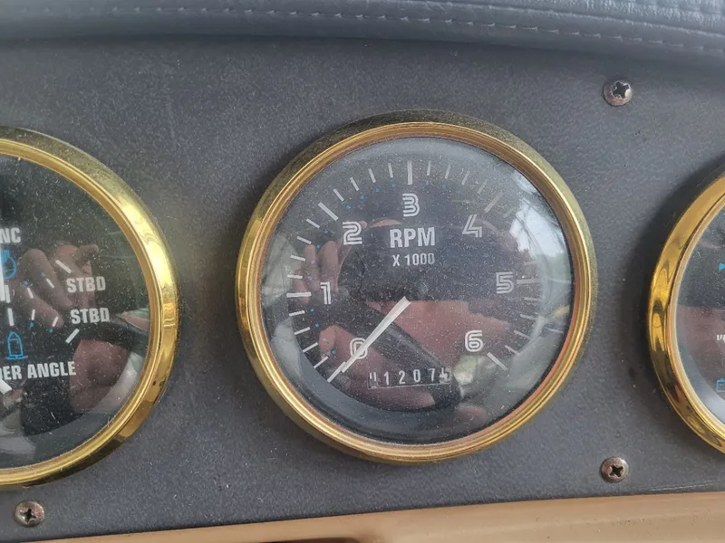 Slide: The Image of 2001 Carver 396 tachometer displaying 12074 RPM. - 15