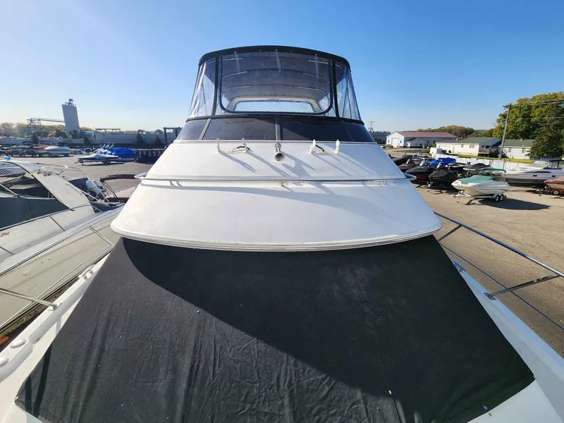 Slide: The Image of 2001 Carver 396 yacht docked in marina under clear skies. - 23