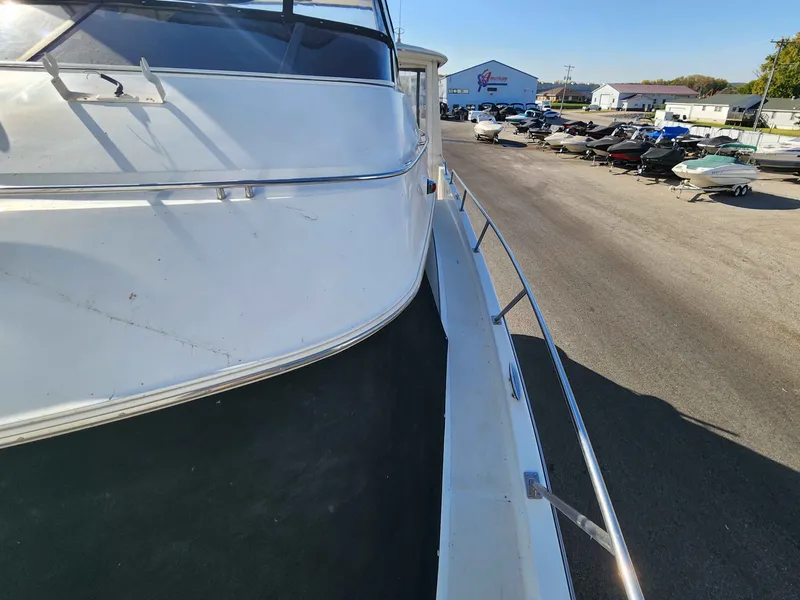 Slide: The Image of 2001 Carver 396 Yacht on a lot with other boats. - 25