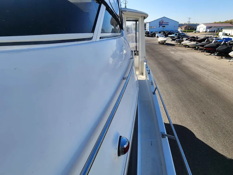 Slide: The Image of Side view of a 2001 Carver 396 yacht outdoors. - 26