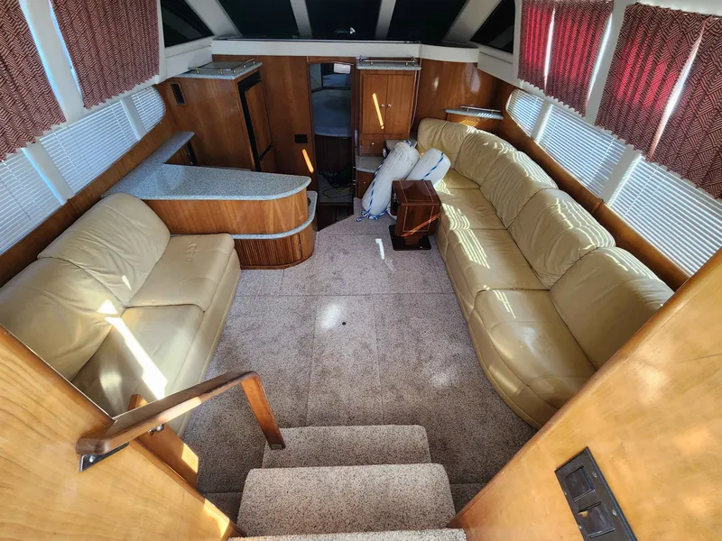 Slide: The Image of Interior of a 2001 Carver 396 yacht with beige leather sofas. - 30