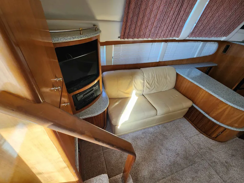 Slide: The Image of Interior of a 2001 Carver 396 yacht with sofa and TV. - 31