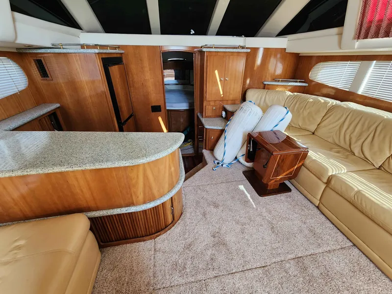 Slide: The Image of Interior of a 2001 Carver 396 yacht with beige sofa and wooden furnishings. - 39