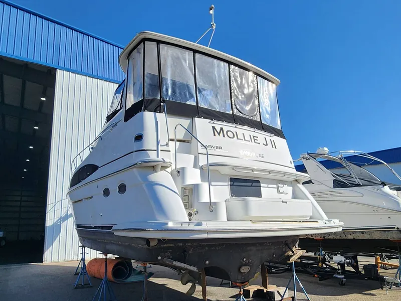 Slide: The Image of 2001 Carver 396 yacht docked outside storage facility. - 4
