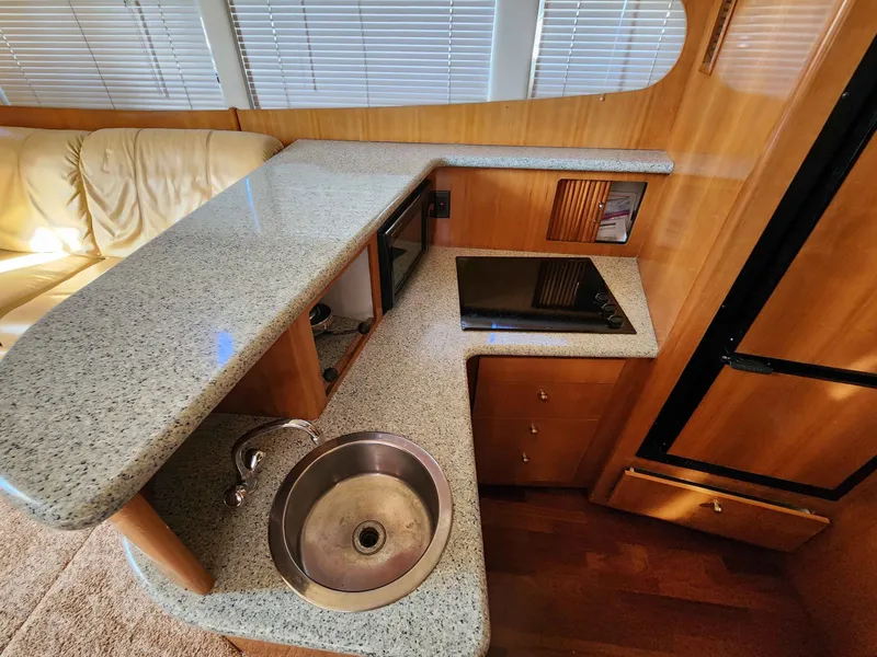 Slide: The Image of Interior of 2001 Carver 396 yacht with kitchen and seating area. - 41