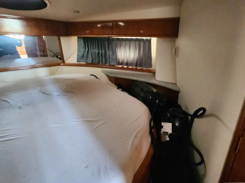 Slide: The Image of Interior of a 2001 Carver 396 yacht with bed and window. - 44