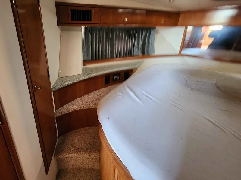 Slide: The Image of Interior of a 2001 Carver 396 yacht with bed and wood paneling. - 45