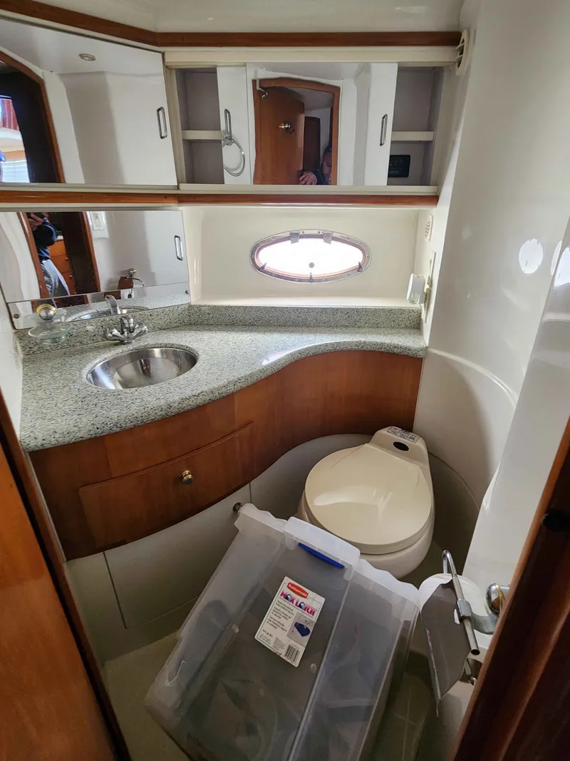 Slide: The Image of Interior of Carver 396 yacht, bathroom with sink and toilet. - 47