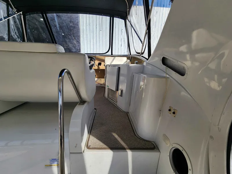 Slide: The Image of Interior of a 2001 Carver 396 yacht with white seating. - 9