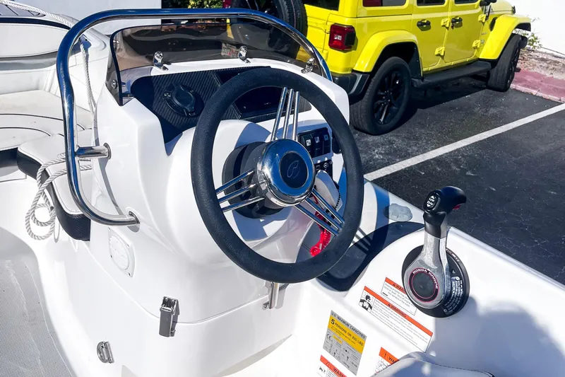 Slide: The Image of 2021 Walker Bay Generation 340 boat dashboard with steering wheel and controls. - 4
