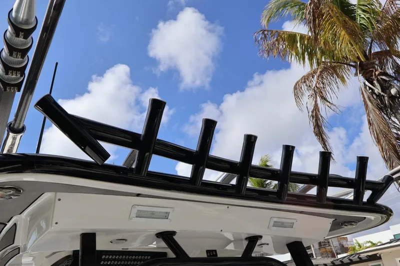 Slide: The Image of 2020 Blackwater 41 Performance Fish boat with rod holders, palm tree, and blue sky background. - 20