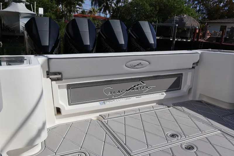Slide: The Image of 2020 Blackwater 41 Performance Fish boat with quad engines, docked in a scenic marina. - 7