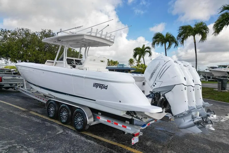 The Image of 2022 Intrepid 345 Nomad FE boat on trailer with triple Mercury engines. - 0