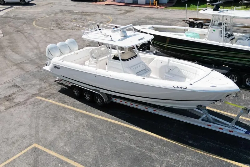 Slide: The Image of 2022 Intrepid 345 Nomad FE boat on trailer in parking lot. - 13