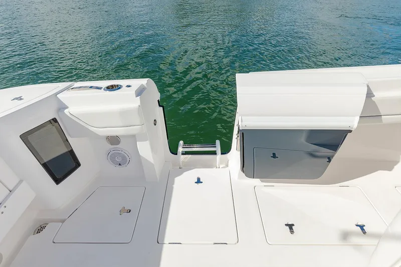 Slide: The Image of Manufacturer Provided Image: 2022 Intrepid 345 Nomad FE boat deck with storage compartments and water access. - 17