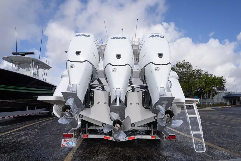 Slide: The Image of Triple outboard engines on a 2022 Intrepid 345 Nomad FE boat, parked outdoors. - 21