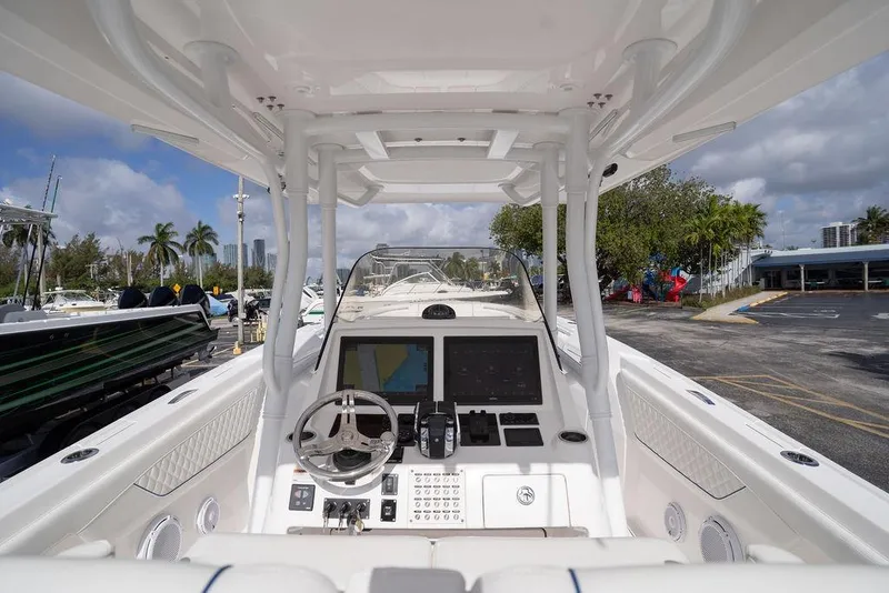 Slide: The Image of 2022 Intrepid 345 Nomad FE boat cockpit with steering wheel and navigation screens. - 23