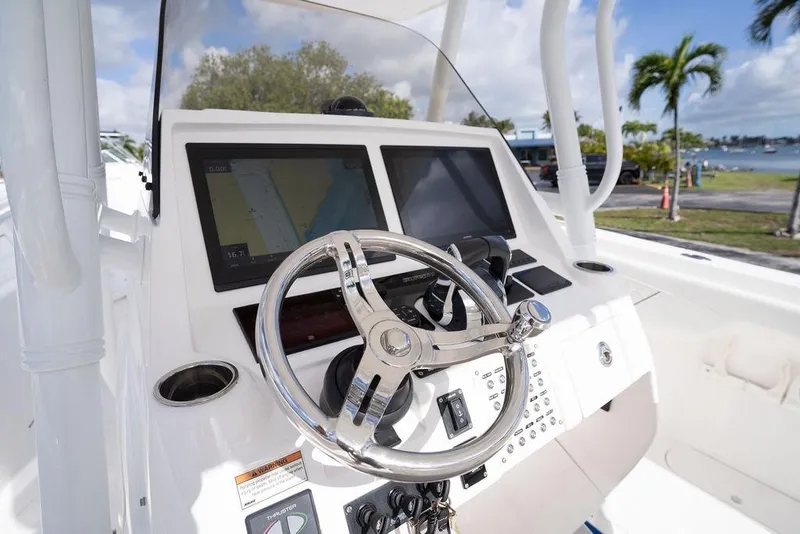 Slide: The Image of 2022 Intrepid 345 Nomad FE boat helm with dual displays and steering wheel. - 25
