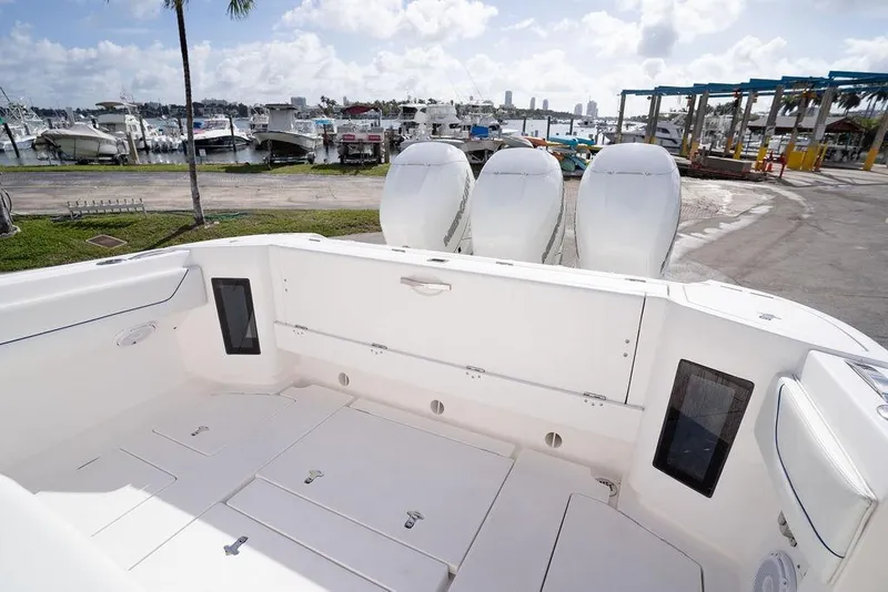 Slide: The Image of 2022 Intrepid 345 Nomad FE boat with triple engines docked at marina. - 27