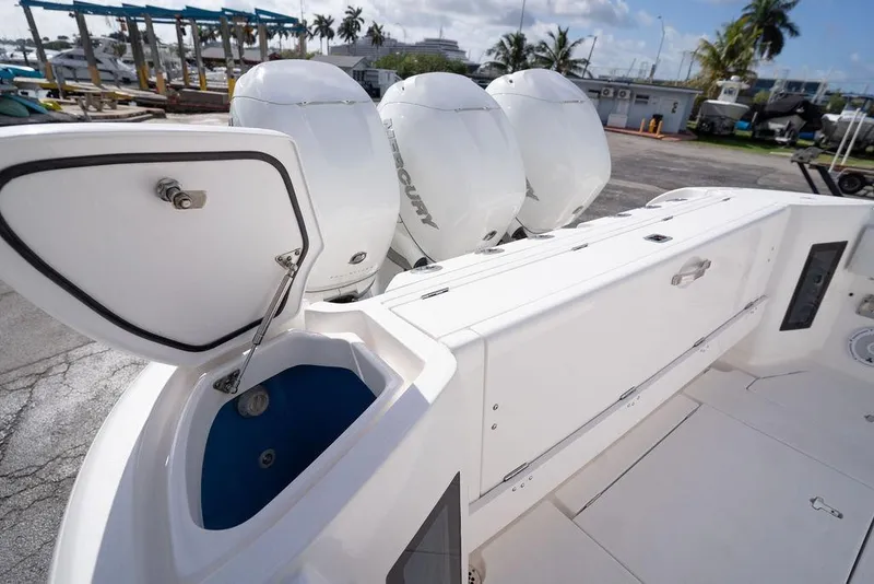 Slide: The Image of 2022 Intrepid 345 Nomad FE boat with open storage compartment and powerful Mercury engines. - 28