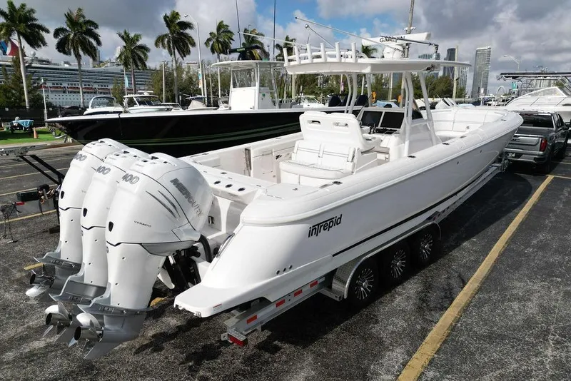 Slide: The Image of 2022 Intrepid 345 Nomad FE boat with triple outboard engines on a trailer. - 3