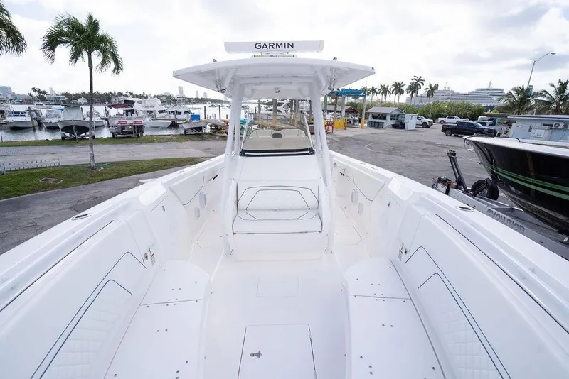 Slide: The Image of 2022 Intrepid 345 Nomad FE boat docked at marina, featuring spacious deck and modern design. - 32