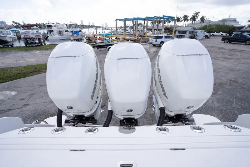 Slide: The Image of Triple Mercury outboard engines on a 2022 Intrepid 345 Nomad FE at a marina. - 39