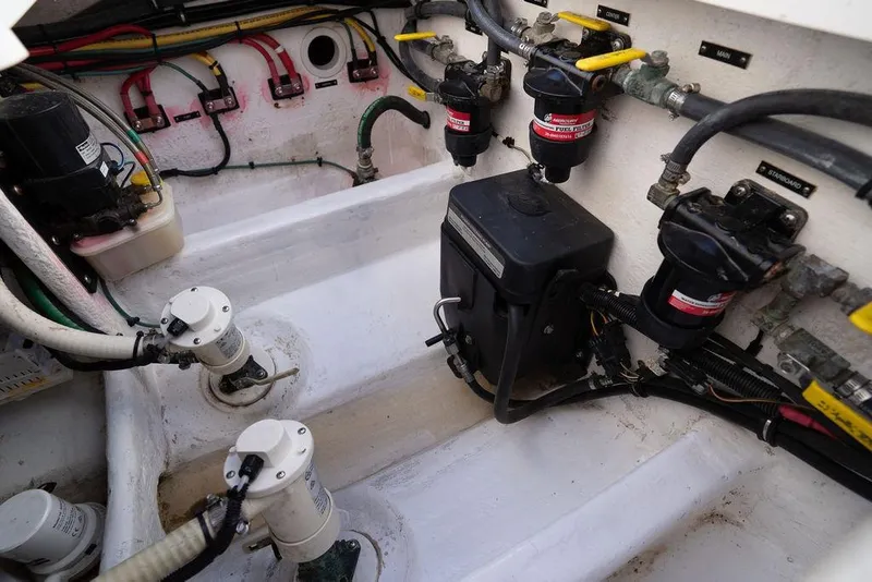 Slide: The Image of Engine compartment of 2022 Intrepid 345 Nomad FE boat, showcasing fuel filters and wiring. - 43