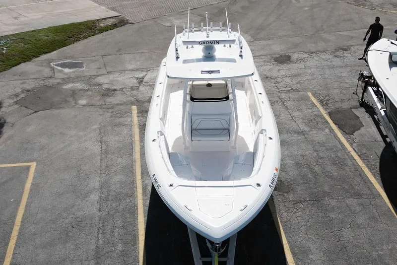 Slide: The Image of 2022 Intrepid 345 Nomad FE boat parked on asphalt, aerial view. - 8