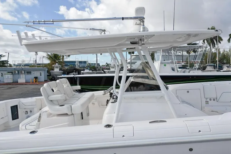 Slide: The Image of 2022 Intrepid 345 Nomad FE boat with sleek white seating and canopy. - 9