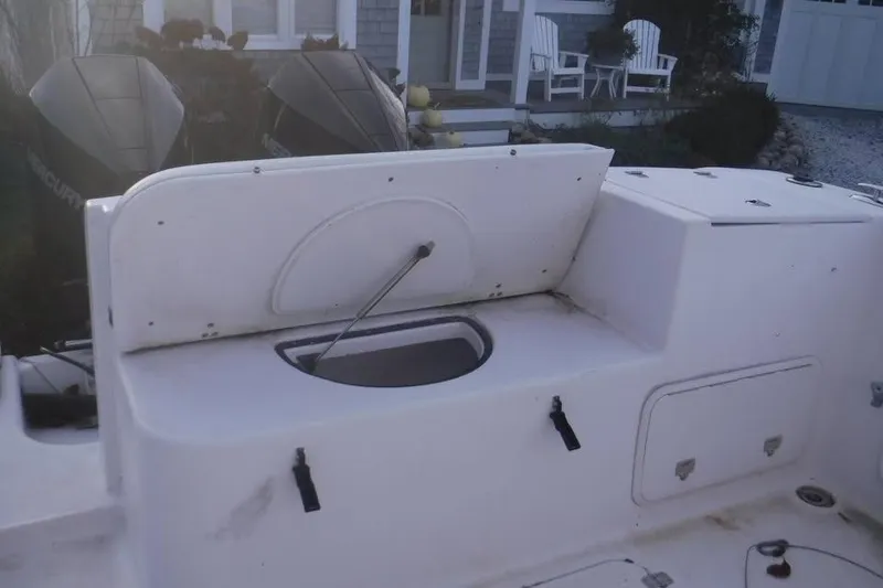 Slide: The Image of 2006 PROLINE 31 Center Console boat interior with open storage compartment and dual Mercury engines. - 7