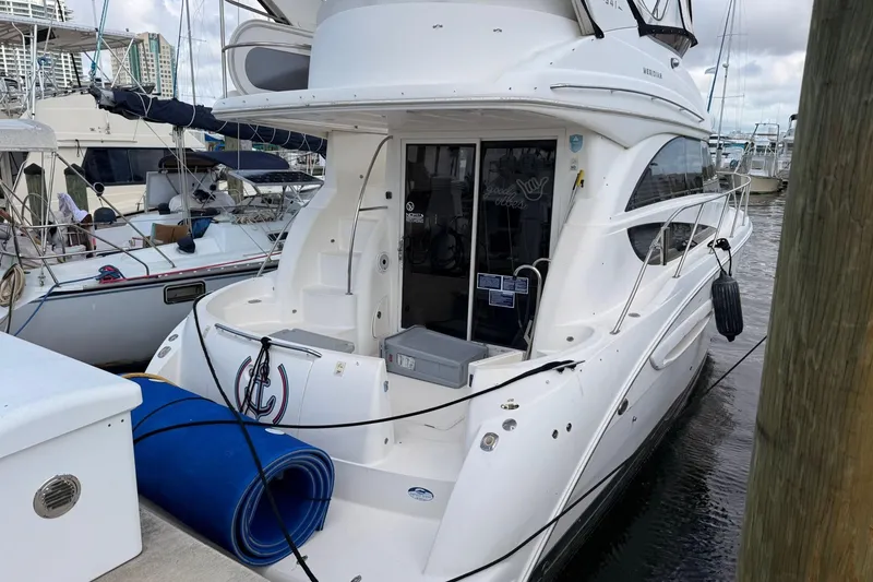 The Image of 2008 Meridian 341 Sedan yacht docked at marina, featuring sleek white design. - 0