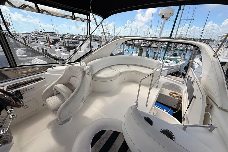 Slide: The Image of 2008 Meridian 341 Sedan yacht interior with white seating, docked at marina. - 16