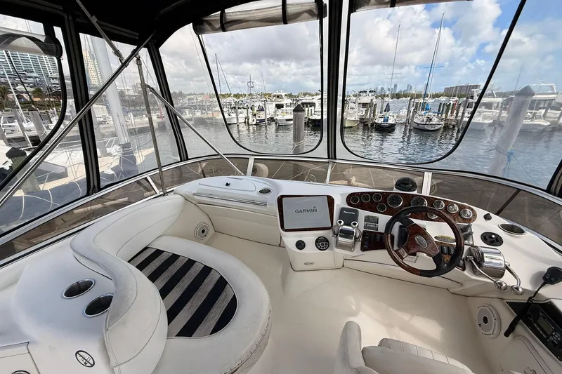 Slide: The Image of 2008 Meridian 341 Sedan yacht cockpit with steering wheel and navigation system, docked at marina. - 18