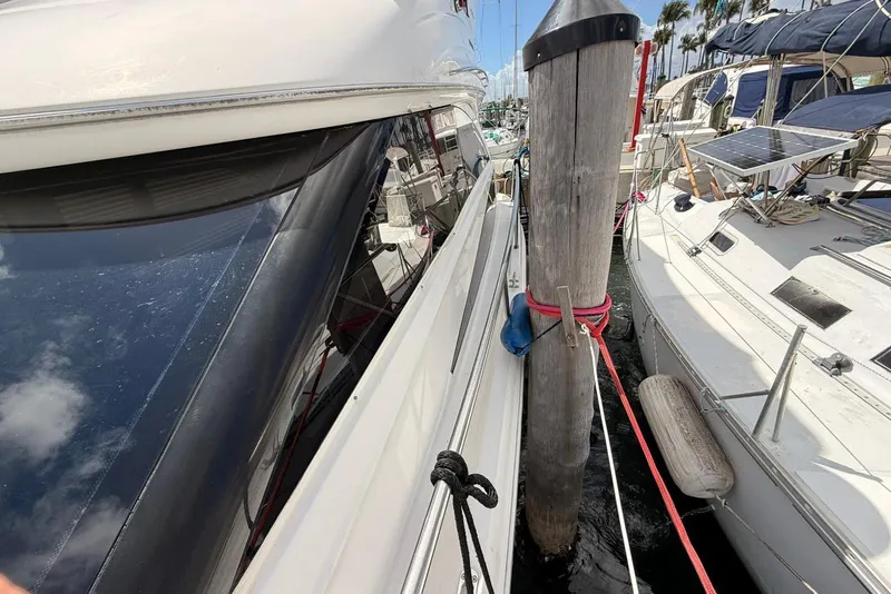 Slide: The Image of 2008 Meridian 341 Sedan yacht docked beside a wooden piling at a marina. - 21
