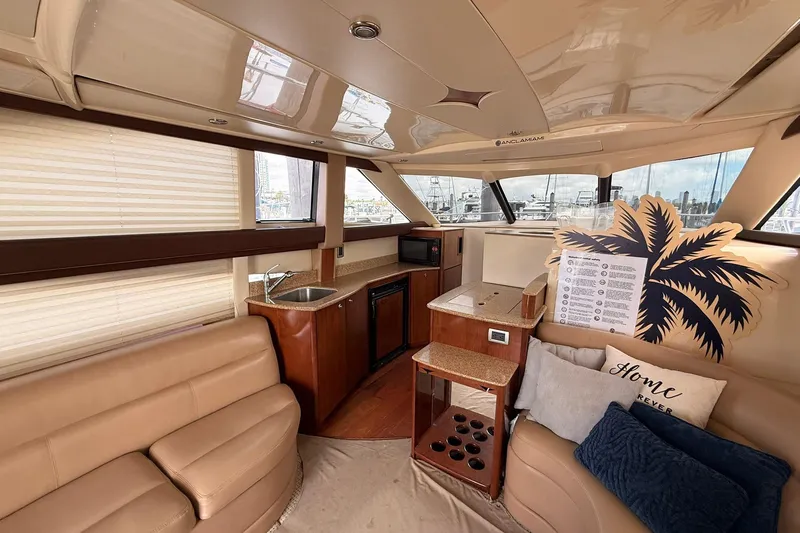 Slide: The Image of Luxurious interior of a 2008 Meridian 341 Sedan yacht with plush seating and kitchenette. - 4