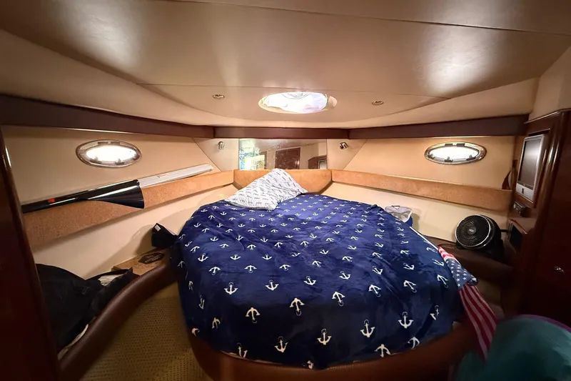 Slide: The Image of Luxurious cabin interior of a 2008 Meridian 341 Sedan yacht with nautical-themed bedding. - 9