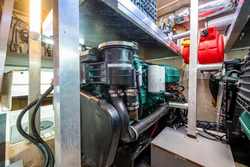 Slide: The Image of Engine room of a 2012 Prestige Flybridge yacht, showcasing mechanical components and equipment. - 104