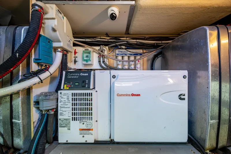 Slide: The Image of Engine room of 2012 Prestige Flybridge with Cummins Onan generator and filtration system. - 105