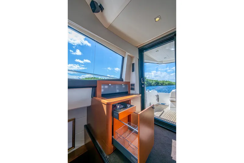 Slide: The Image of Interior of 2012 Prestige Flybridge yacht with open cabinet and ocean view. - 40