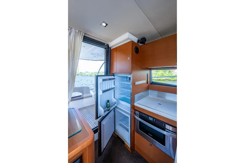 Slide: The Image of Interior of 2012 Prestige Flybridge yacht with open fridge and modern kitchen amenities. - 45