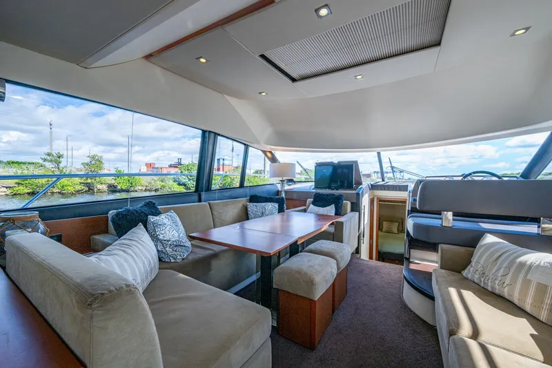 Slide: The Image of Luxurious 2012 Prestige Flybridge yacht interior with plush seating and panoramic windows. - 48