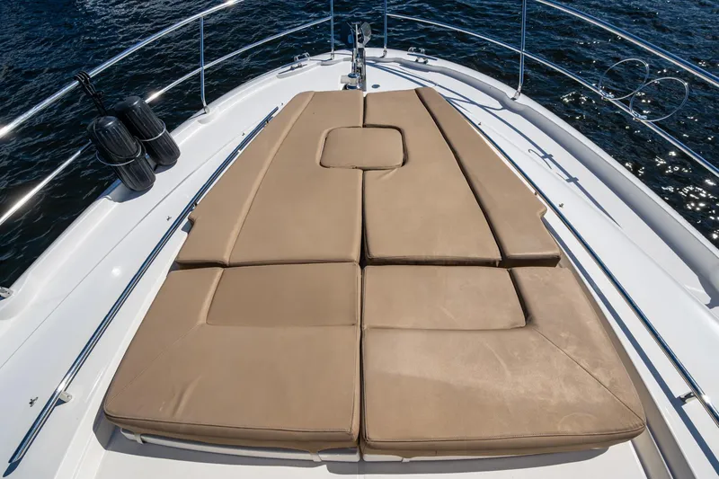 Slide: The Image of Prestige Flybridge 2012 yacht with tan sunbathing cushions on deck, surrounded by water. - 65