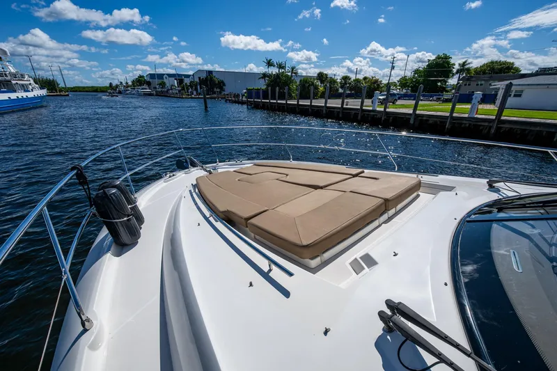 Slide: The Image of 2012 Prestige Flybridge yacht with sunbathing deck on a sunny day by the water. - 67