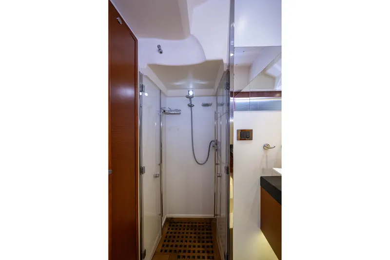 Slide: The Image of Luxurious shower area in 2012 Prestige Flybridge yacht, featuring modern fixtures and wooden flooring. - 75