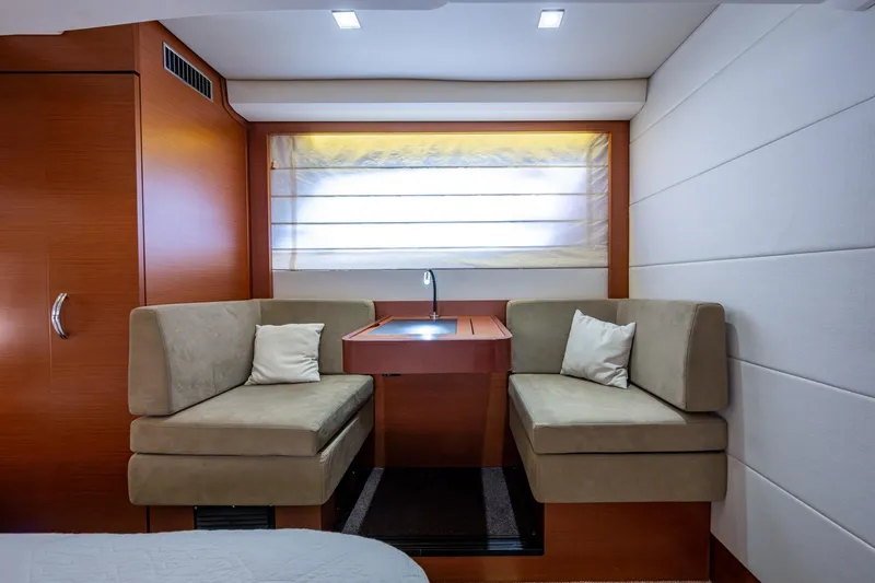 Slide: The Image of Luxurious 2012 Prestige Flybridge yacht interior with cozy seating and elegant wood finishes. - 77