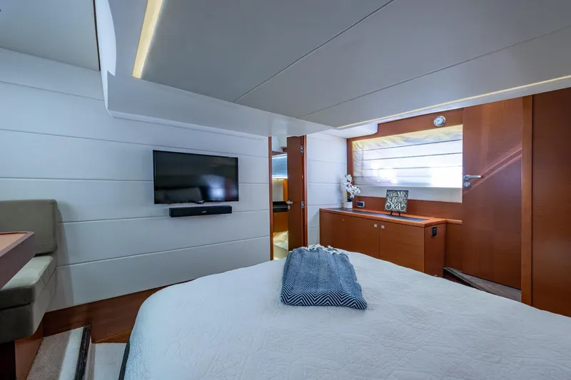 Slide: The Image of Luxurious 2012 Prestige Flybridge yacht bedroom with modern decor and flat-screen TV. - 82