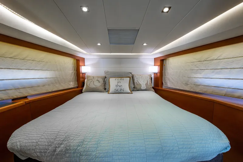 Slide: The Image of Luxurious bedroom interior of 2012 Prestige Flybridge yacht with cozy bedding and ambient lighting. - 98