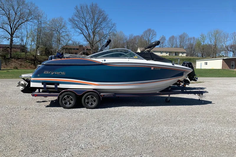 The Image of 2015 Bryant Calandra boat on trailer, parked outdoors on gravel surface. - 0