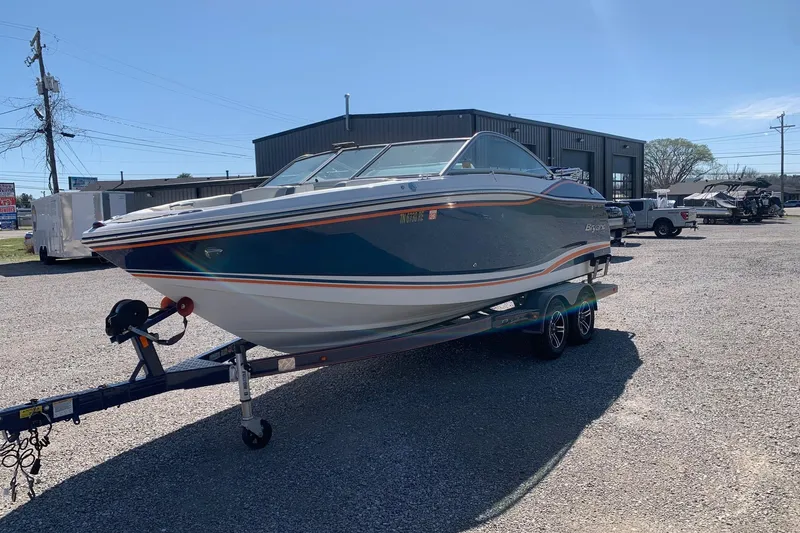 Slide: The Image of 2015 Bryant Calandra boat on trailer in outdoor lot, sunny day. - 1